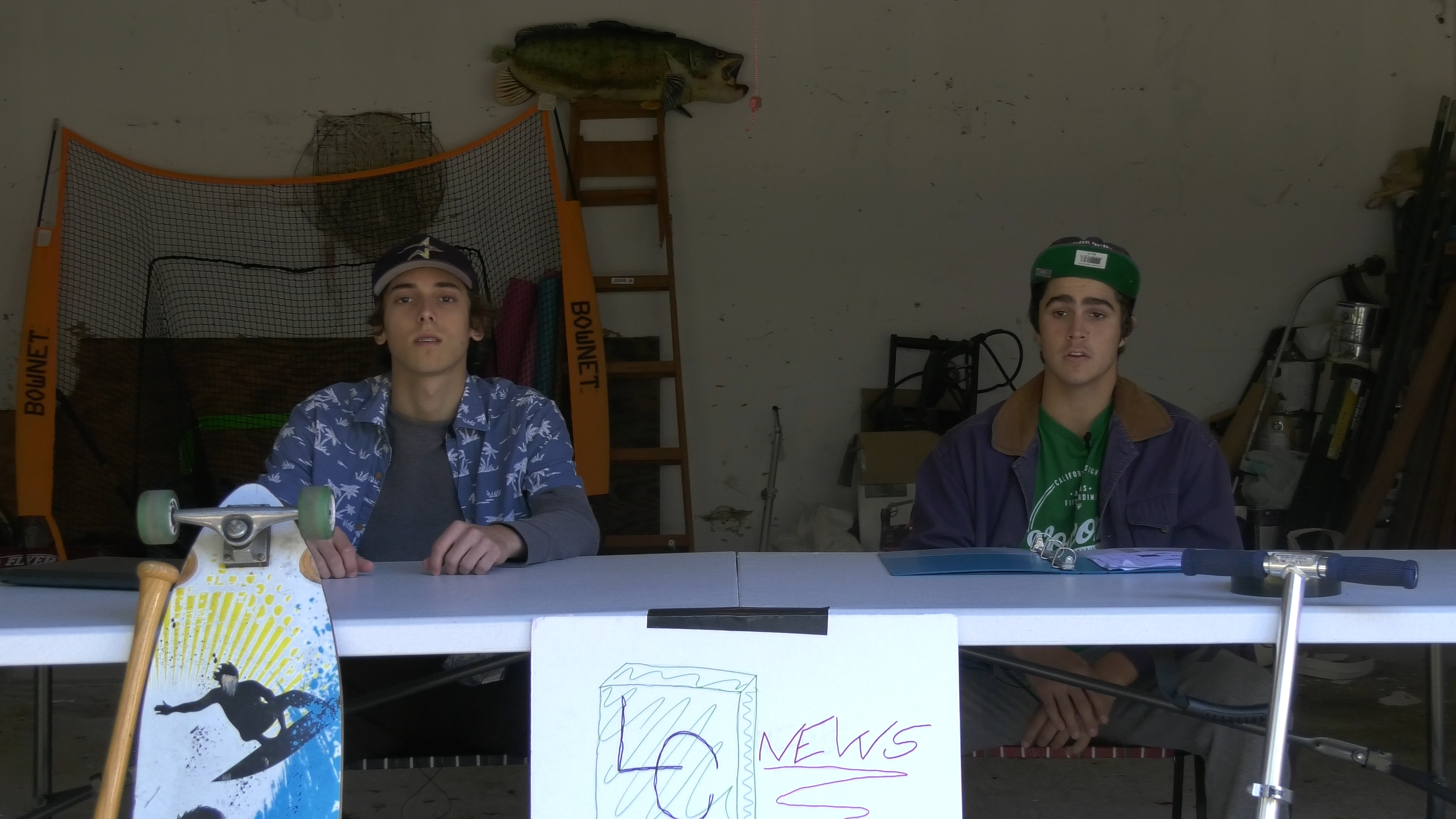 Jack Brown and Chris Skladal sitting at a table in a garage